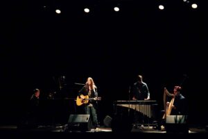 Patti Smith performing on a dark stage